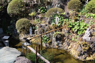 In the Hase-kannon temple complex garden with stone statues in Kamakura, Japan in March