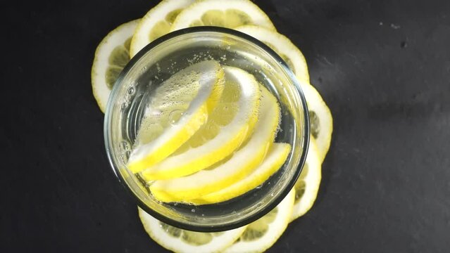 Citrus Fruits with Lemon Water and Bubbles Sound on black Background