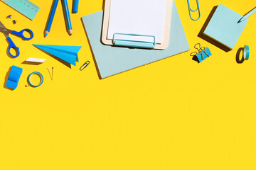 School supplies on a yellow background.	
