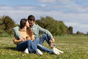 man and woman enjoying outdoors while loving each other in a city park