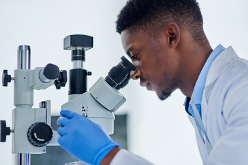 Science, research and black man with microscope for analysis, investigation or medical engineering...