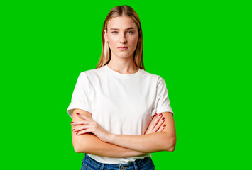 Young Woman in White Shirt Posing for Picture against green background - 788417249
