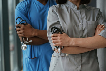 Man and woman doctors are standing together indoors with stethoscope
