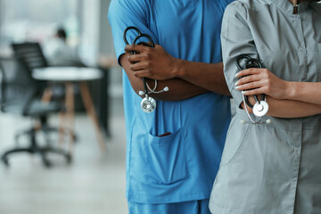 Close up view. Man and woman doctors are standing together indoors with stethoscope