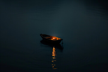 A small boat on a lake with light in the dark