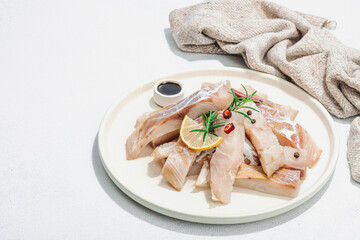 Raw pollock (Pollachius virens) fillet. Fresh fish for healthy food lifestyle. Spices and herbs