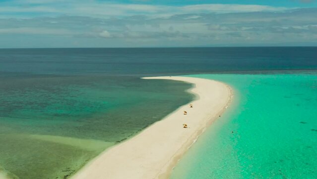Beautiful beach on tropical island surrounded by coral reef, sandy bar with tourists, top view. Sandbar Atoll. Summer and travel vacation concept, Camiguin, Philippines.
