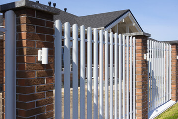 Modern white picket fence at a residential house