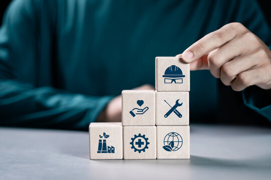 HSE, Health safety environment concept. Standard safe industrial work and industrial. Person stacking wooden block with HSE icon for business and organization.