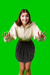 Young Woman Gesturing Excitement in Casual Attire Against Green Screen Backdrop