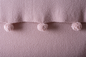 The knitted texture is the same color as a dusty rose.