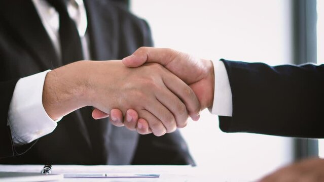 Asian businessmen together create a mutually beneficial business relationship. The economic graph on the table.