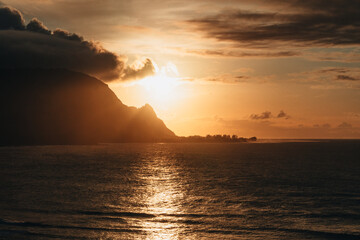 hawaii sunset over the mountain shoreline and ocean