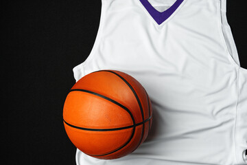 Close-Up of Basketball and White and Purple Jersey on a Black Background - 788459432