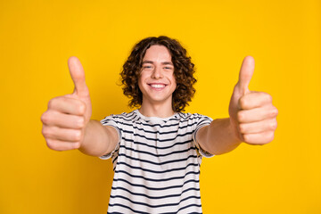 Portrait of young optimistic teenager guy in t shirt double thumbs up rating high quality education...