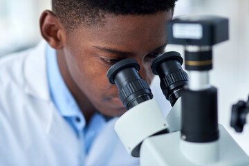 Science, research and black man with microscope for engineering, investigation or medical analysis in laboratory. Biotech, lab technician or scientist checking vaccine sample for pharmaceutical test.