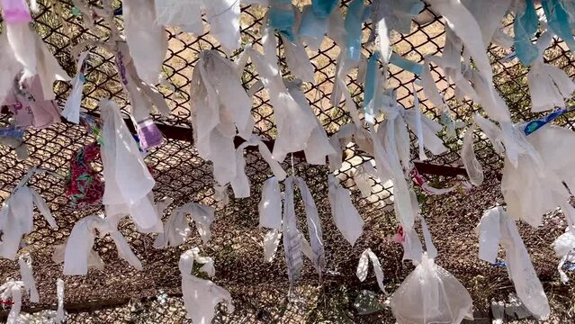 ribbons of desires tied to fancy against backdrop of a mountain and blue sky on Chimgan mountain, Uzbekistan