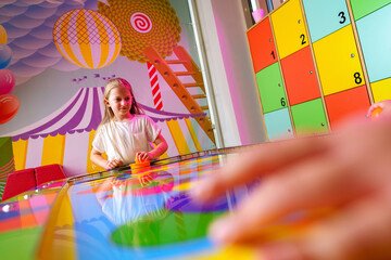 Young Girl Engaging in Colorful Board Game Fun at a Vibrant Playroom