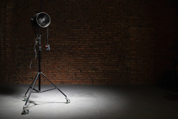 Axial photostudio fan on the brick wall background. Photo studio equipment.