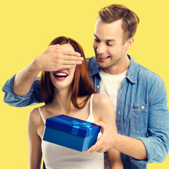 Love, dating, celebrating, lovers concept - happy amorous couple with blue gift box. Image of young...