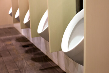 white modern urinals in a men's washroom