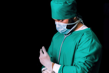 male caucasian doctor wearing medical gloves for protection in operation. professional surgical man putting clean rubber gloves on his hand. male nurse wearing mask and clean gloves before procedure