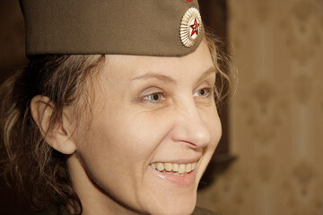 Close-up portrait of a woman in a military cap. Close-up, retro portrait. Vintage historical...