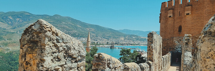 banner of view from old fortress wall of tower, city and sea, as well as minarets of the mosque. Alanya Turkey. soft focus.