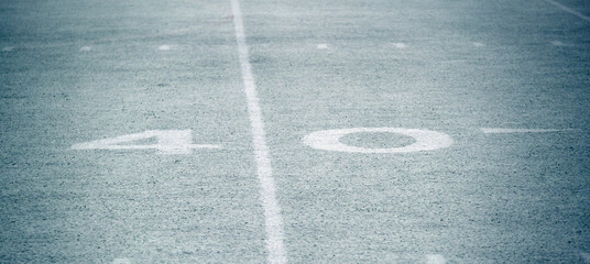 Snow Covered Football Field with Yardage Marks on Grass - obrazy, fototapety, plakaty