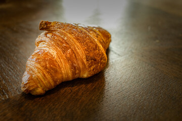 traditional french croissant on wooden table