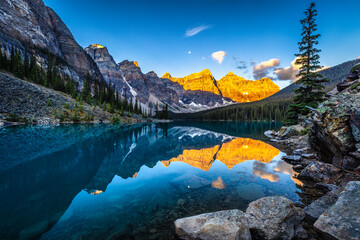Alpine lake in mountains at sunrise. Moraine Lake in Banff National Park, Canadian Rockies,...