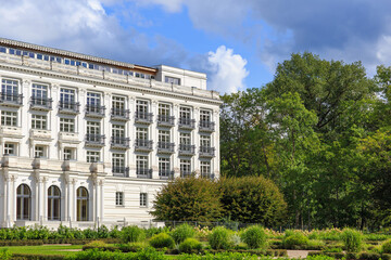 white hotel building in a summer park