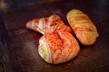 variety of french viennoiseries on wooden surface