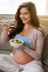 Smile, eating and pregnant woman with salad on sofa for wellness, diet and health at home. Happy, maternity and female person enjoying food, meal or dinner with vegetables in living room at house.