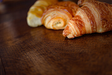 variety of french viennoiseries on wooden surface