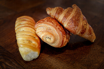 variety of french viennoiseries on wooden surface