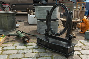 oval mirror on a furniture cupboard design offered for sale at a flea market