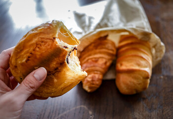 variety of ffreshly baked rench viennoiseries on wooden surface