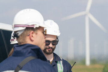 Wind farm engineers conducting a field assessment for turbine maintenance operations.