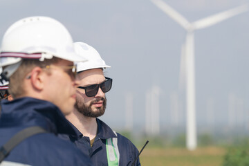 Wind farm engineers conducting a field assessment for turbine maintenance operations.