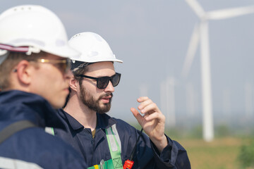 Wind energy technicians with hardhats and safety gear ready to inspect turbines.
