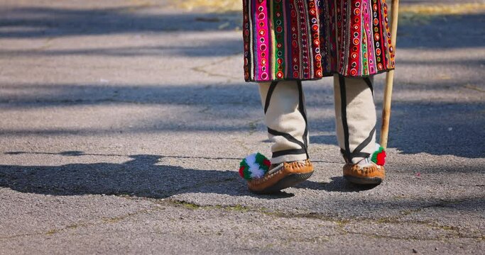 Bulgarian Kukers with bells and traditional costumes, masked people kukeri dancing in masquerade festival Kukerlandia, Yambol, Bulgaria