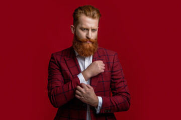 Elegance of bearded gentleman in formal suit. Formalwear. Tux man in formalwear isolated on red. Redhead man in formalwear tuxedo. Man wear elegant formal menswear. Black-tie tuxedo
