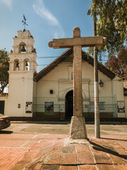 Monument of the Stone Cross with the San Bernardino church in the background in Bosa, Bogotá -...