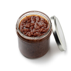 Glass jar with traditional homemade black olive tapenade close up on white background
