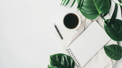 Blank notepad, cup of coffee and leaves on the table 
