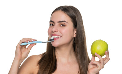 Woman with white smile brushing teeth with electric toothbrush hold apple - 788538872