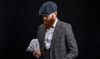 Englishman with money. Rich man in retro suit. Brutal gentleman has successful business. Man with casino money. Bearded man businessman. Rich Englishman. Retro man isolated on black