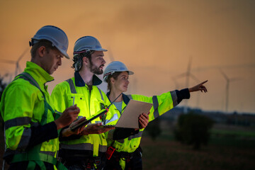Team Engineers men and woman checking and inspecting on construction with sunset sky. people...