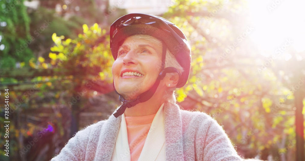 Sticker cycling, face and helmet with senior woman outdoor in garden for retirement recreation or wellness. 